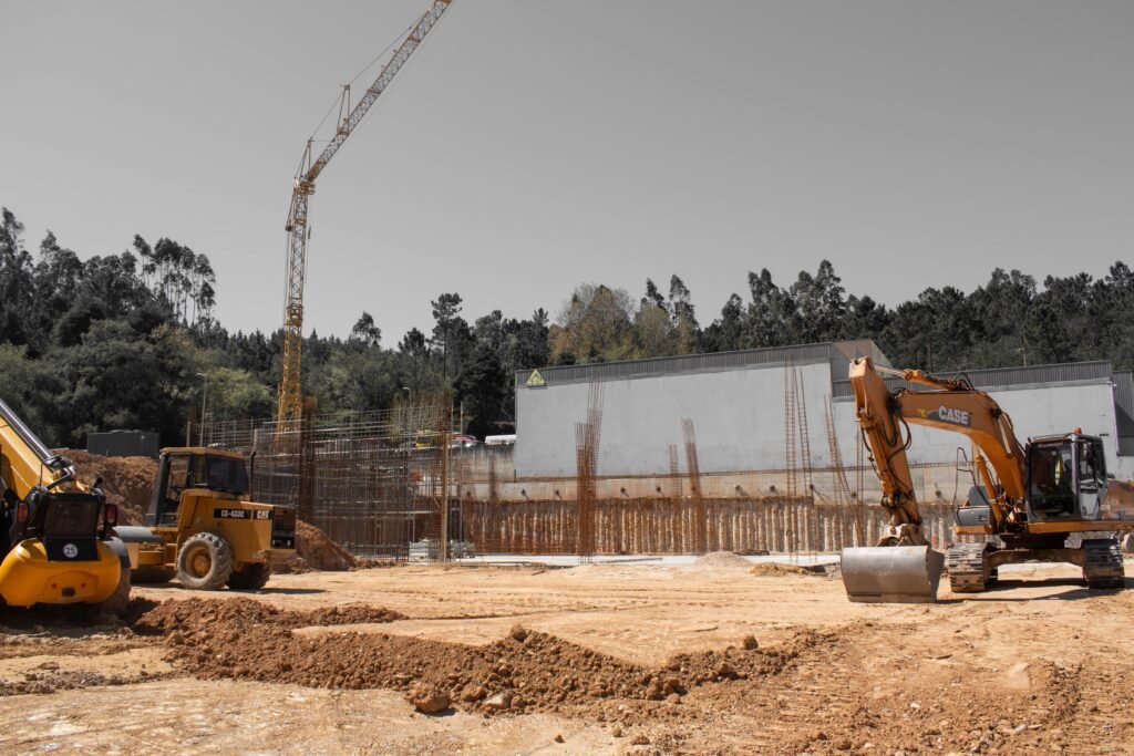 A busy construction site with cranes and heavy machinery for building infrastructure.